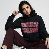 Person wearing a black hoodie with 'Roberts Wesleyan' text, sitting on a white background.